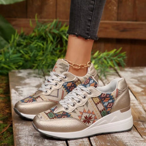Geometric patterned wedge sneakers in gold with a chunky sole and lace-up closure.