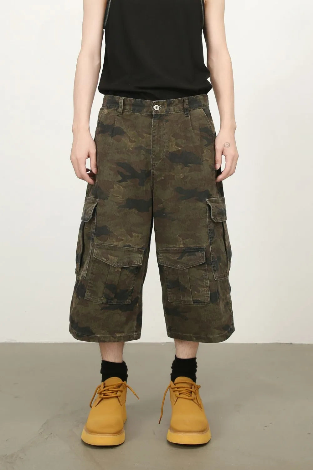 Camo culotte cargo shorts in green camouflage with multiple pockets.