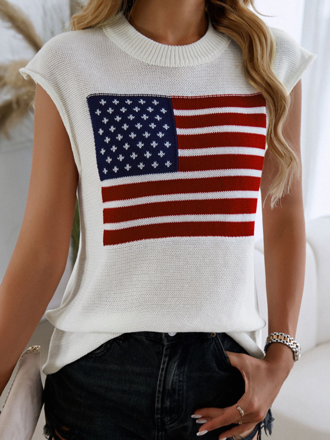 White knit vest with American flag graphic, crew neck, sleeveless.