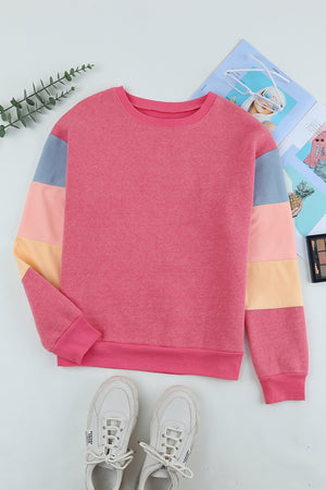 Pink color block sweatshirt with crewneck and long sleeves.