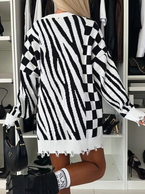 Black and white zebra stripe knit tunic with distressed hem and checkerboard sleeves.