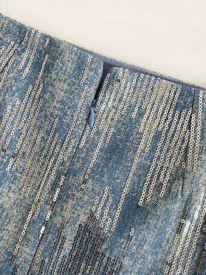 Light blue sequin mini skirt with zipper detail and distressed denim texture.
