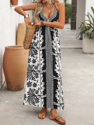 Maxi dress with halter neck, deep V, and black and white floral print.