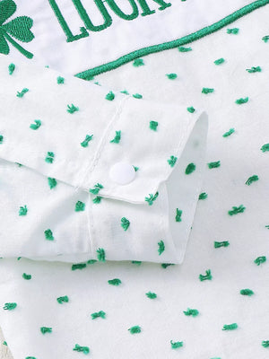 White cotton baby set with green embroidered shamrocks and text, featuring a buttoned cuff.