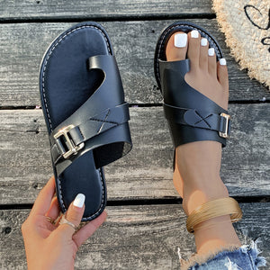 Chic black toe loop flat sandals with buckle detail and criss-cross straps.