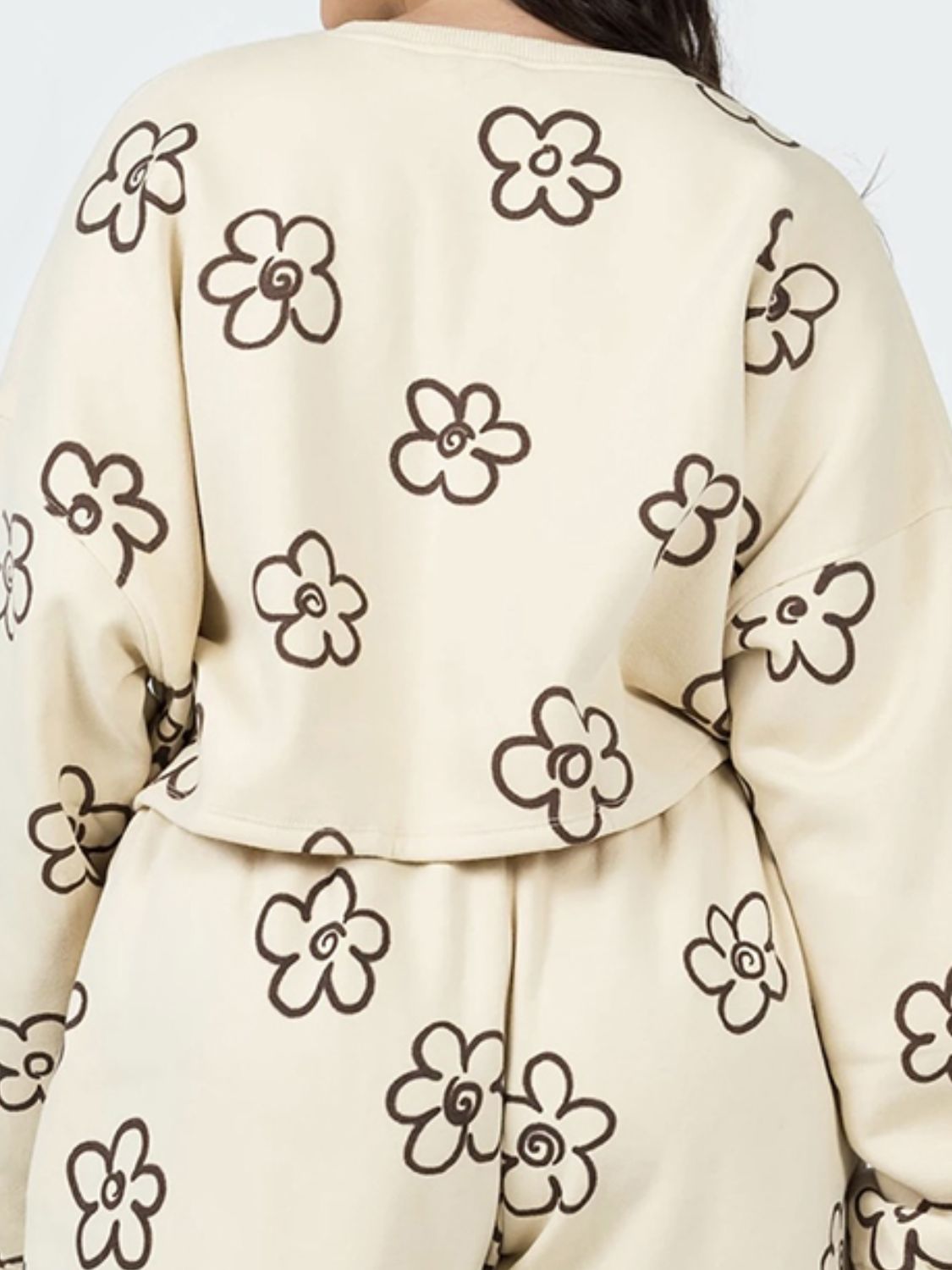 Ivory cropped lounge set with brown drawn floral pattern.