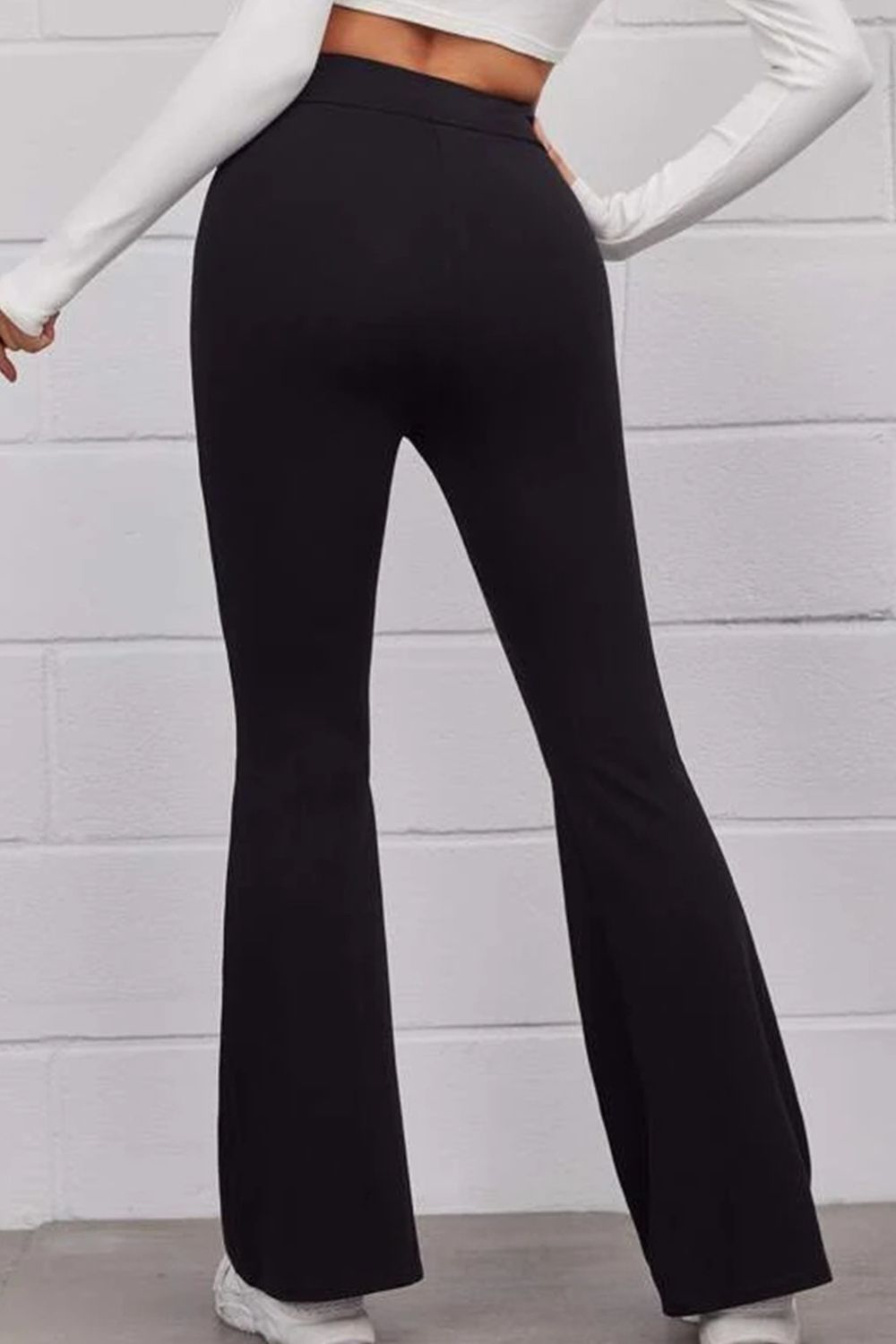 Black flare freestyle trousers with a high waist, showing the back view.