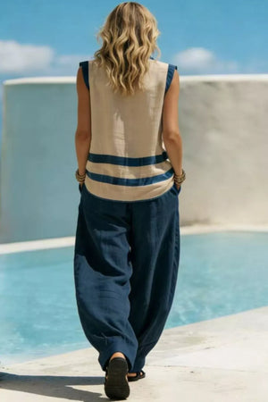 Women's navy flowy pants and a beige sleeveless top with blue stripes.