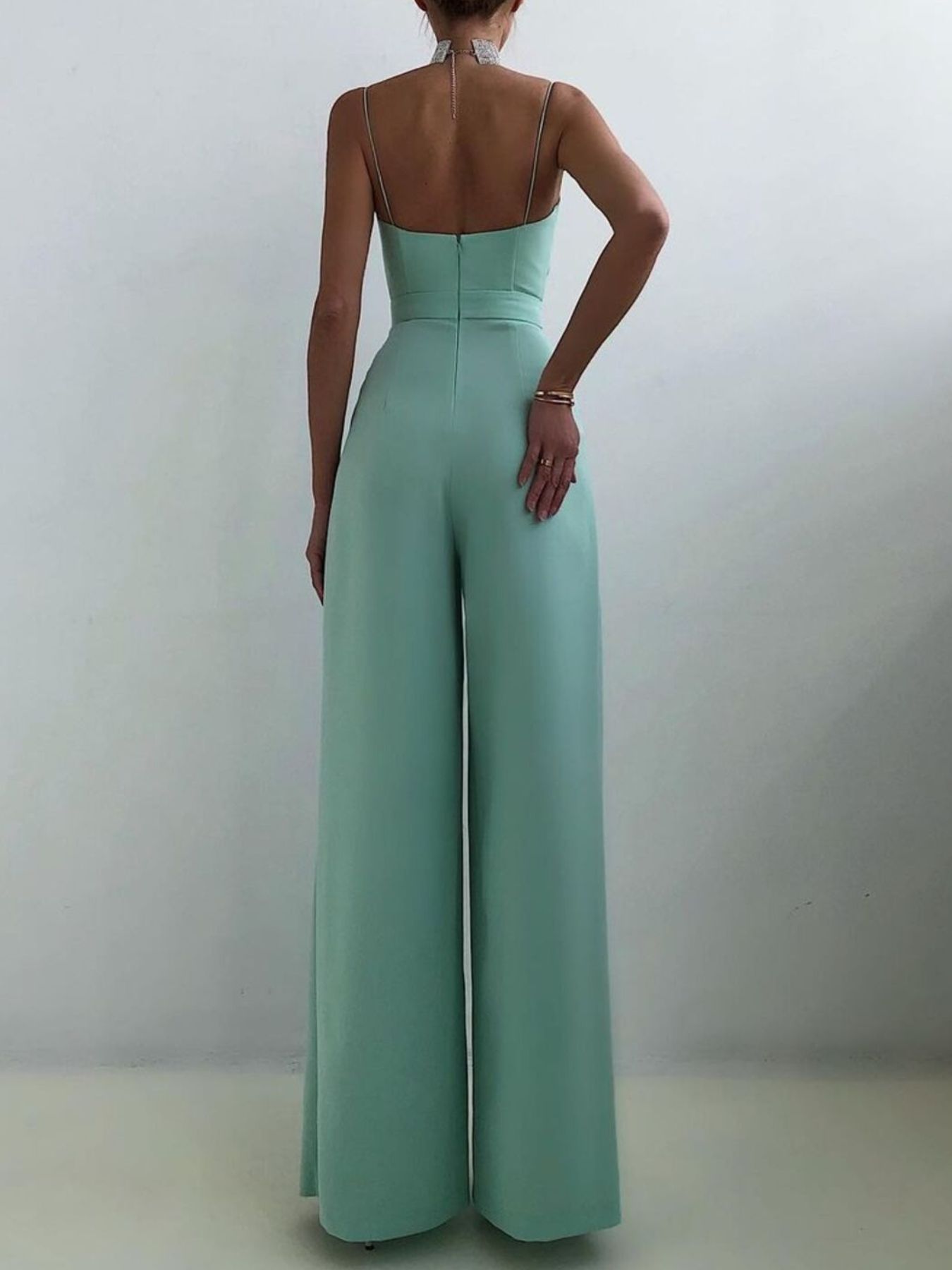 Mint green ruched spaghetti strap wide-leg jumpsuit with a high waist.