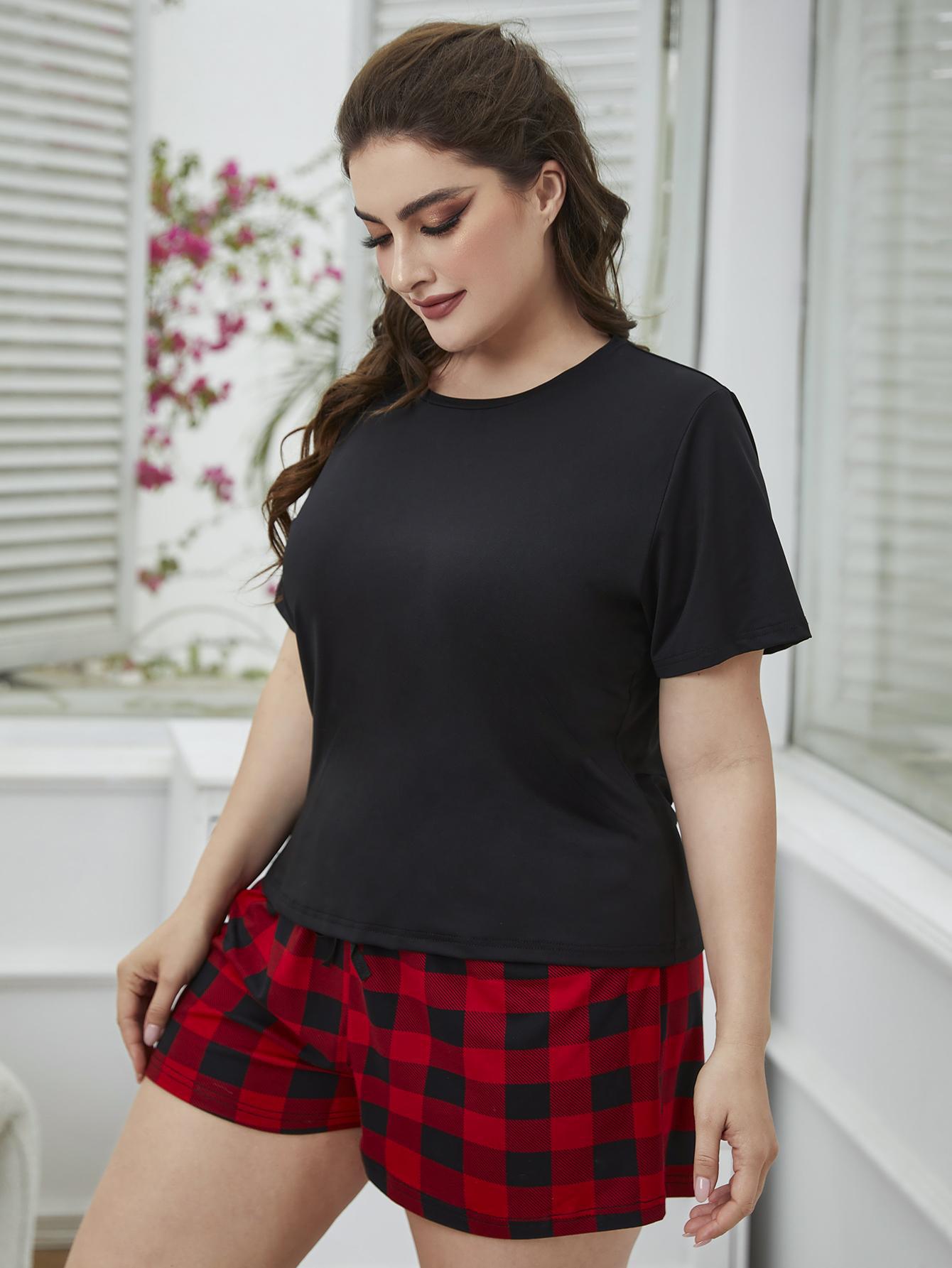 Relaxed black tee with red and black plaid shorts set.