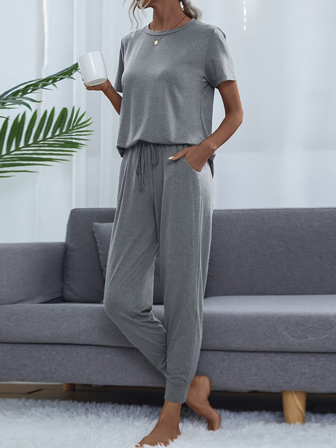 Relaxed-fit charcoal tee and jogger set with drawstring waist and pockets.