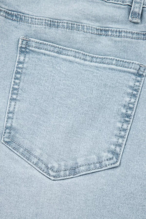 Light wash denim jeans back pocket detail with contrast stitching.