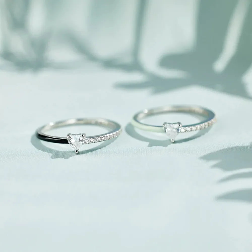 Sterling silver rings with pave bands and heart-shaped stones in black and light green