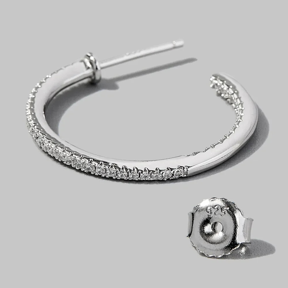 Silver pavé zirconia half-hoop earrings with 925 sterling silver backing.