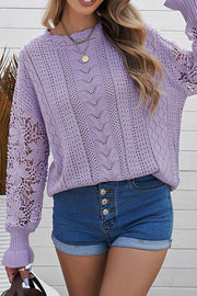 Lavender openwork knit sweater with lace sleeves and detailed stitching.