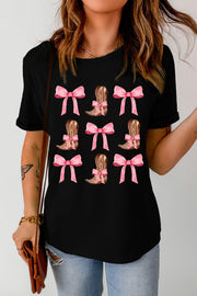 Black t-shirt with a repeating pattern of pink bows and cowboy boots tied with pink bows.