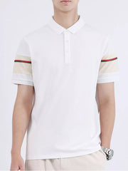White combed cotton polo with striped sleeve accents and a classic collar.