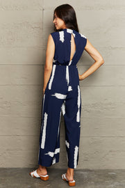 Navy brushstroke print jumpsuit with keyhole back detail and wide legs.
