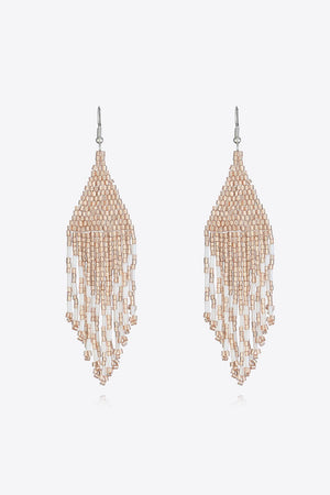 Prismatic beaded fringe earrings in apricot and clear beads with a cascading design.