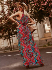 Red floral print maxi dress with braided straps and a belted waist.