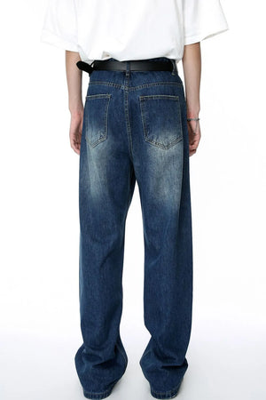 Baggy denim jeans in medium wash with distressed details and a relaxed fit.