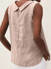 Sleeveless Peter Pan collar blouse in a light pinkish-beige color with a back seam detail.
