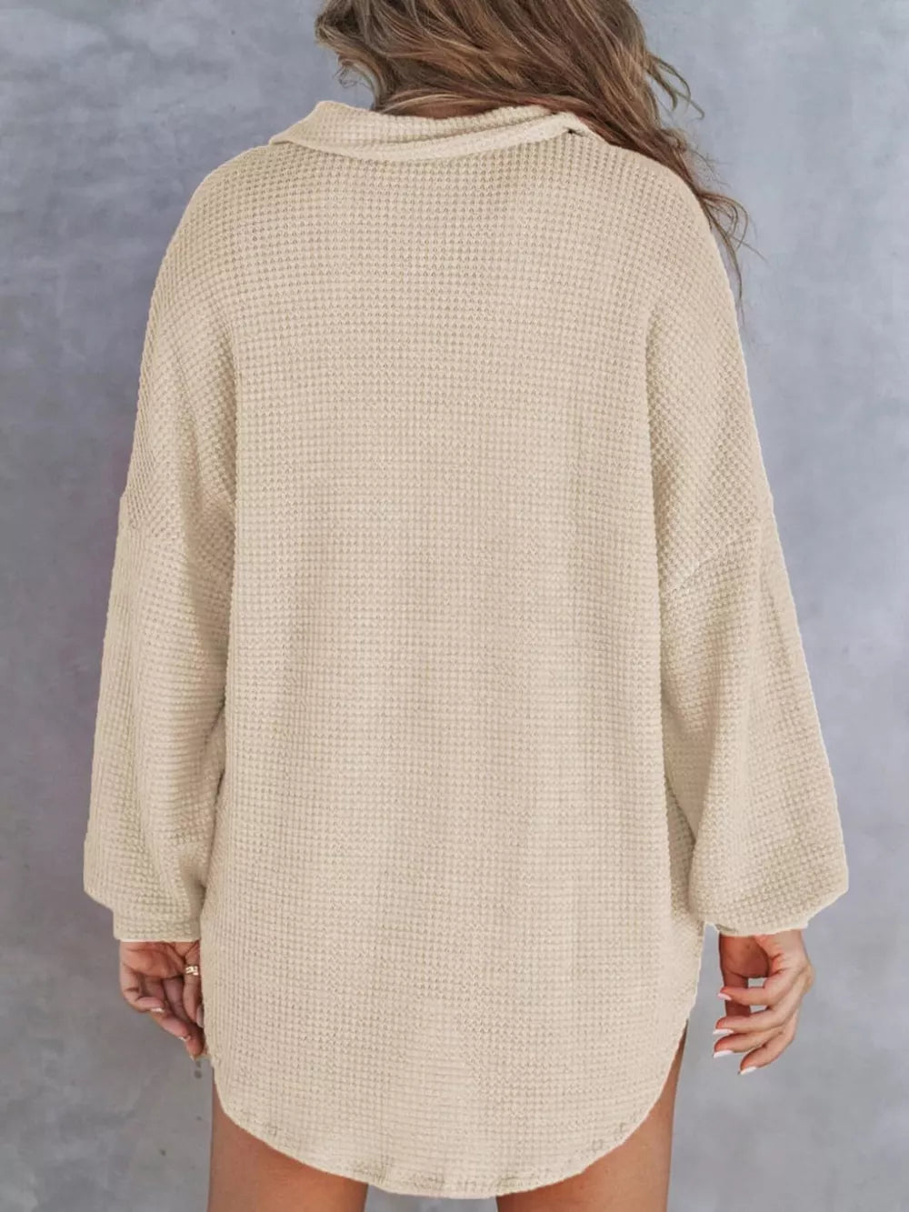 Apricot waffle-knit henley tee with buttoned collar and long sleeves.