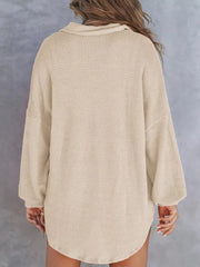 Apricot waffle-knit henley tee with buttoned collar and long sleeves.