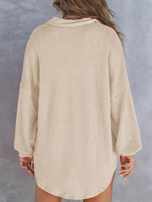 Apricot waffle-knit henley tee with buttoned collar and long sleeves.