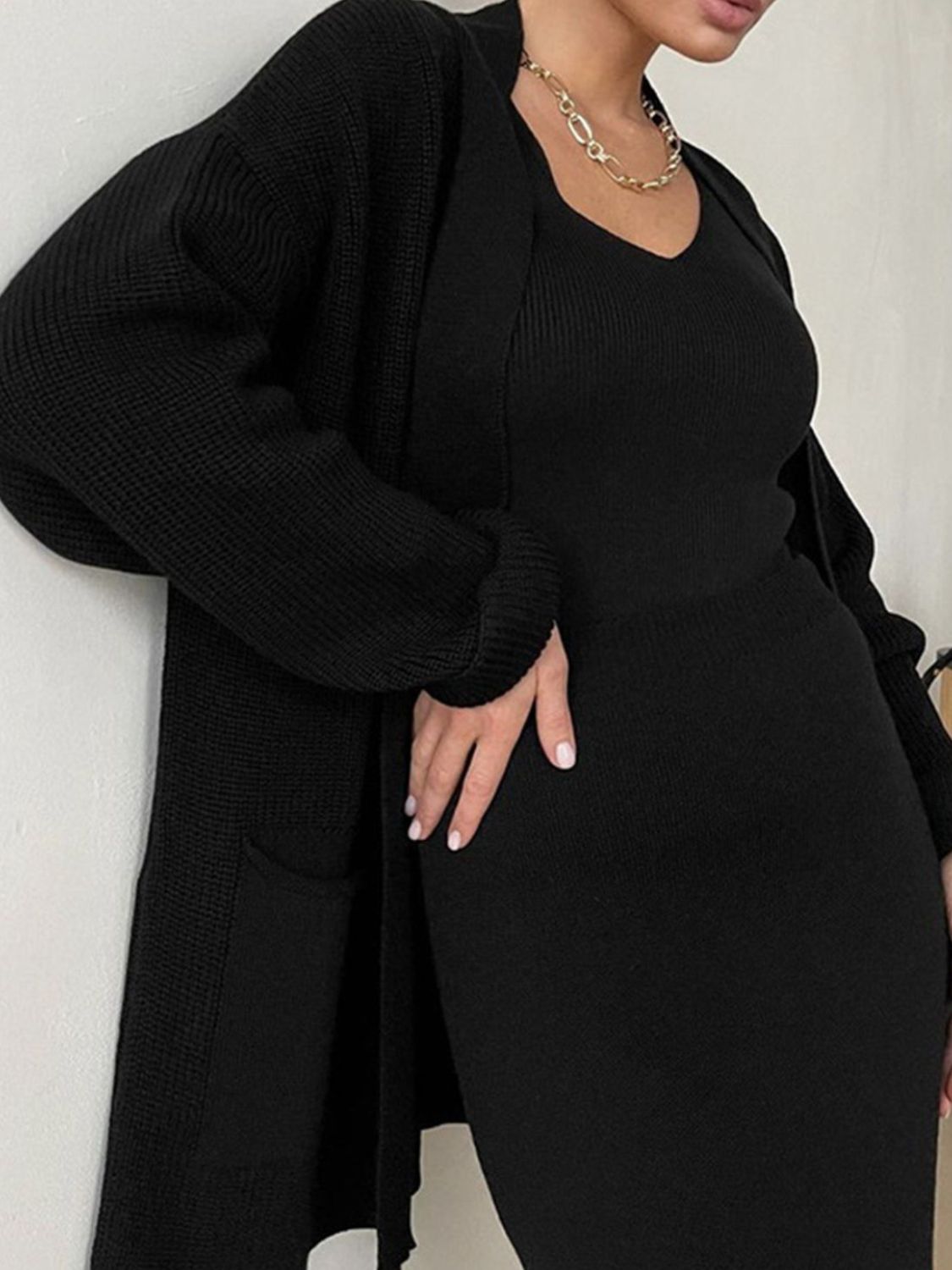 Black ribbed knit co-ord set with a V-neck tank and long cardigan with pockets.