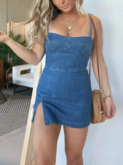 Blue denim mini dress with tie straps, sweetheart neckline, and thigh-high slit.