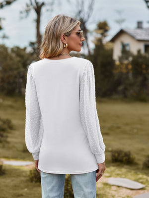 White Swiss dot sleeve V-neck top with long bishop sleeves.