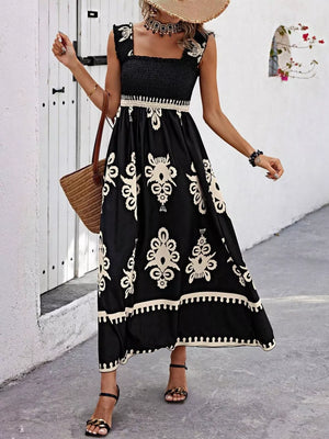 Black smocked square neck maxi dress with cream damask print and ruffled sleeves.