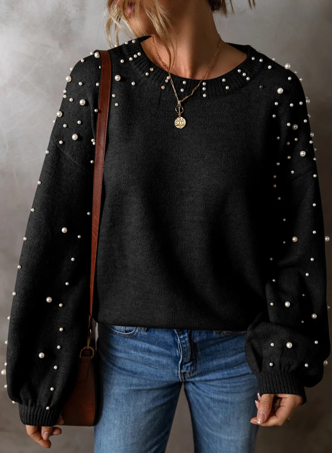 Black long sleeve sweater with pearl embellishments on neckline and sleeves