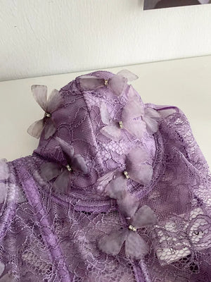 Purple lace bustier top with sheer butterfly appliques and crystal details.