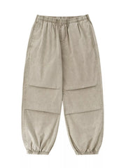 Khaki relaxed fit cargo pants with elastic waist and cuffs, and paneled legs.