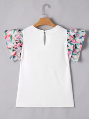 White geometric knit top with floral ruffled sleeves and keyhole back detail.
