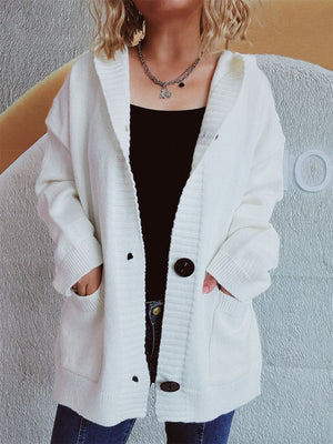 White chunky knit hooded cardigan with button front and pockets.
