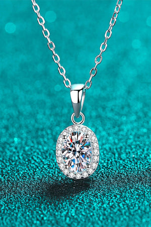 Silver halo moissanite pendant necklace with oval center stone and diamond accents on sterling silver chain