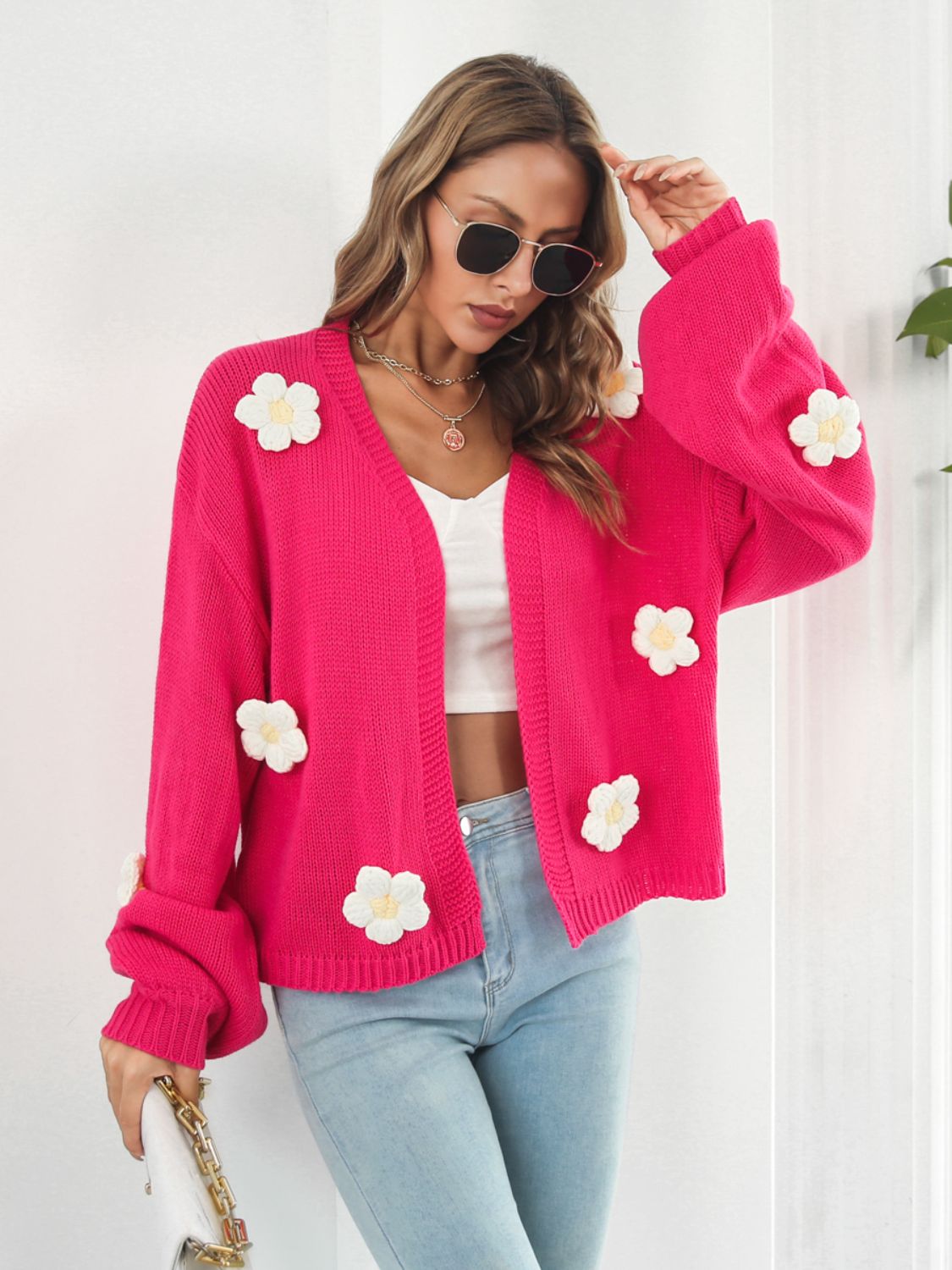 Hot Pink knit cardigan with floral appliqués and balloon sleeves.