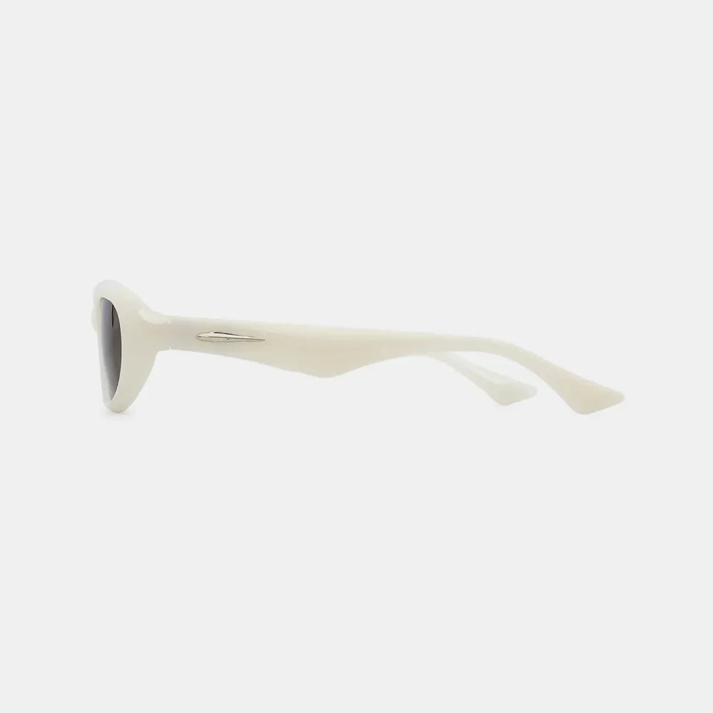 Ivory cat eye sunglasses with a sleek, modern design and silver accent detail.