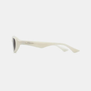 Ivory cat eye sunglasses with a sleek, modern design and silver accent detail.