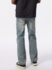 Men's light wash wide-leg jeans with distressed details and moto-inspired stitching.