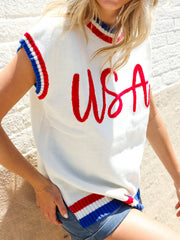 White knit sweater vest with red USA embroidery and red, white, blue striped trim.