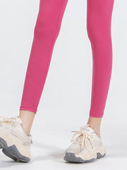 Hot Pink high-waist leggings with a smooth finish, shown with athletic shoes.