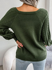 Army green cable-knit sweater with buttoned shoulder detail and balloon sleeves.