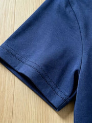 Navy blue cotton t-shirt sleeve with double-stitched hem detail.