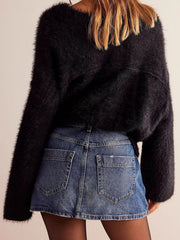 Denim skort in blue with button front and asymmetrical hem.