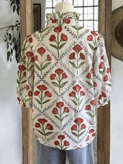 Ruffle collar blouse with red floral print and puff sleeves.