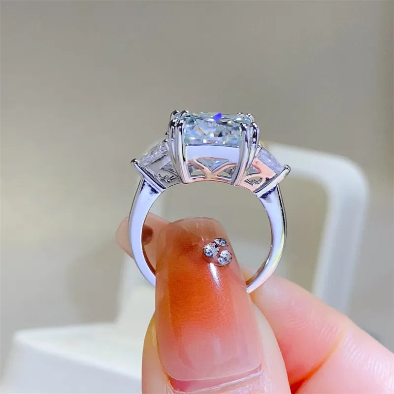Sterling silver ring with a large center moissanite and two trillion-cut side stones.